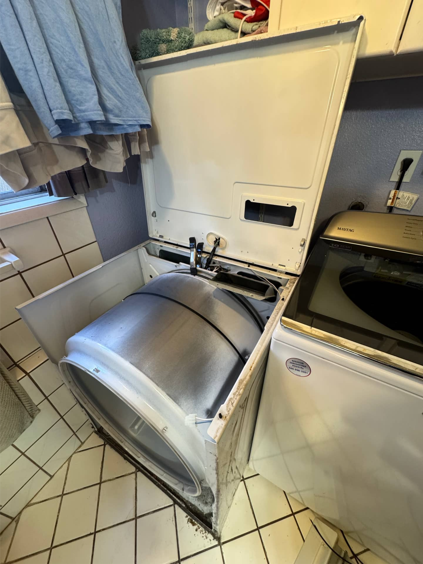 Dryer repair technician servicing dryer in Tigard, OR 