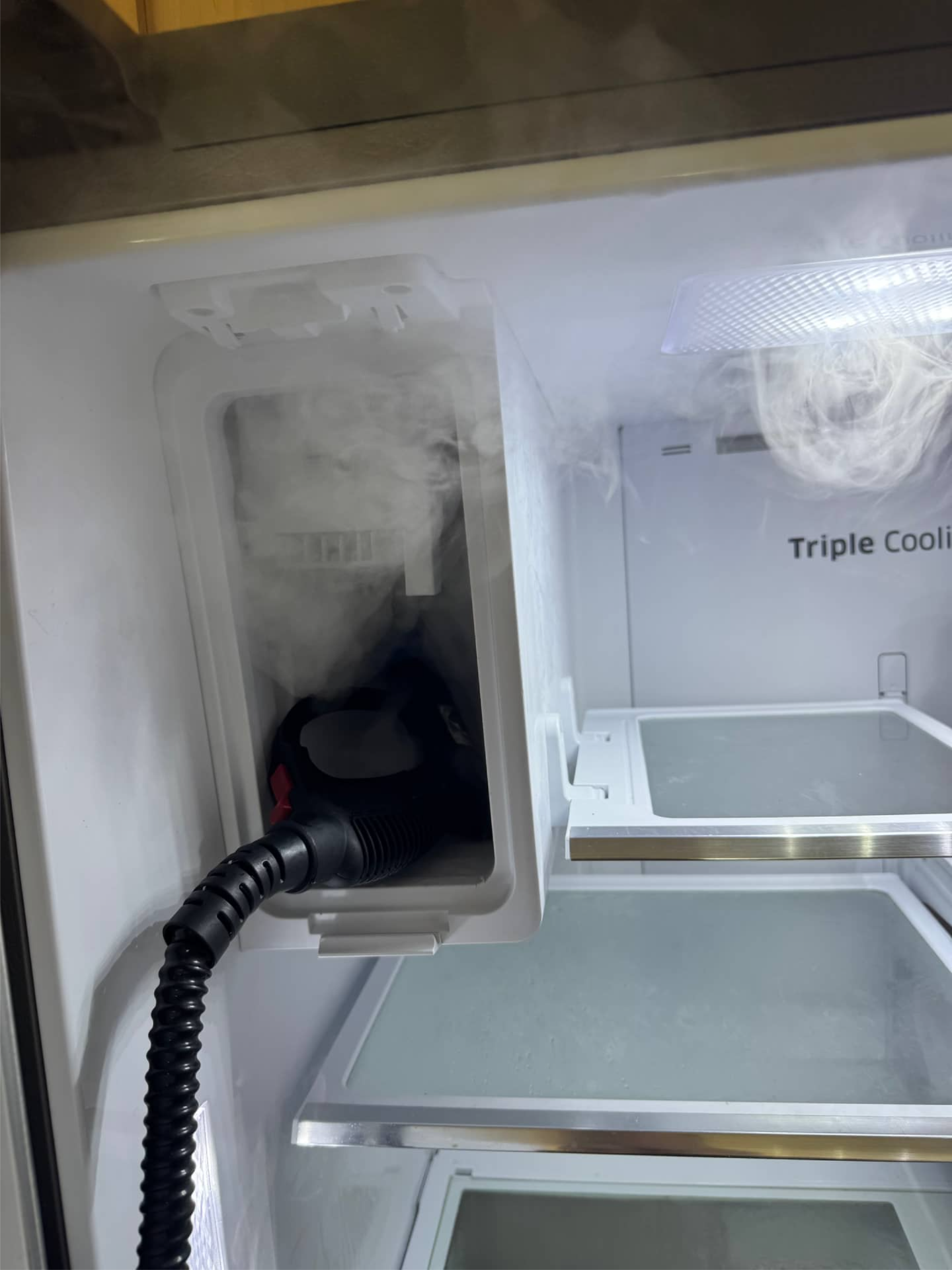 Samsung refrigerator ice maker compartment being serviced in Vancouver, WA 98685