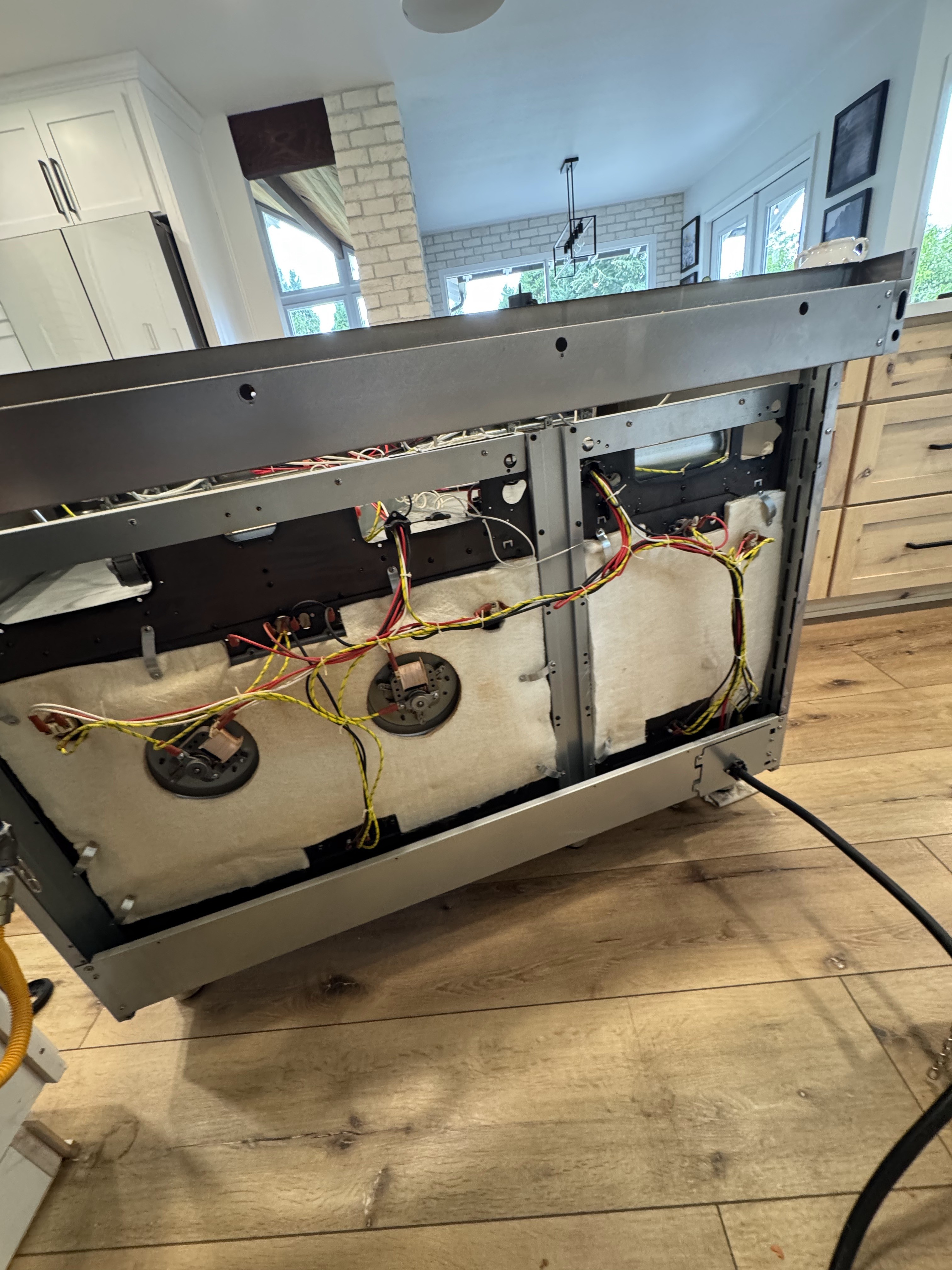 Rear panel removed from Bertazzoni gas range during thermostat repair in Portland, OR 97224