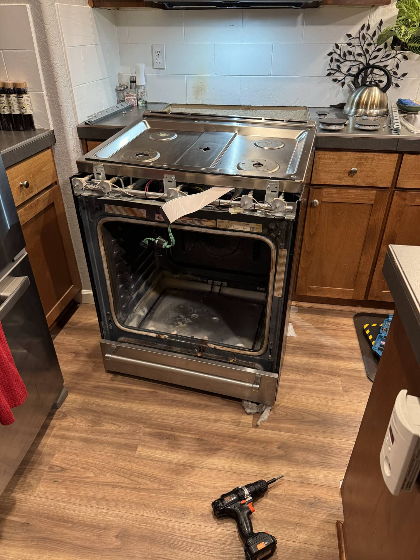 Appliance repair technician servicing KitchenAid Oven in Milwaukie, OR 97267